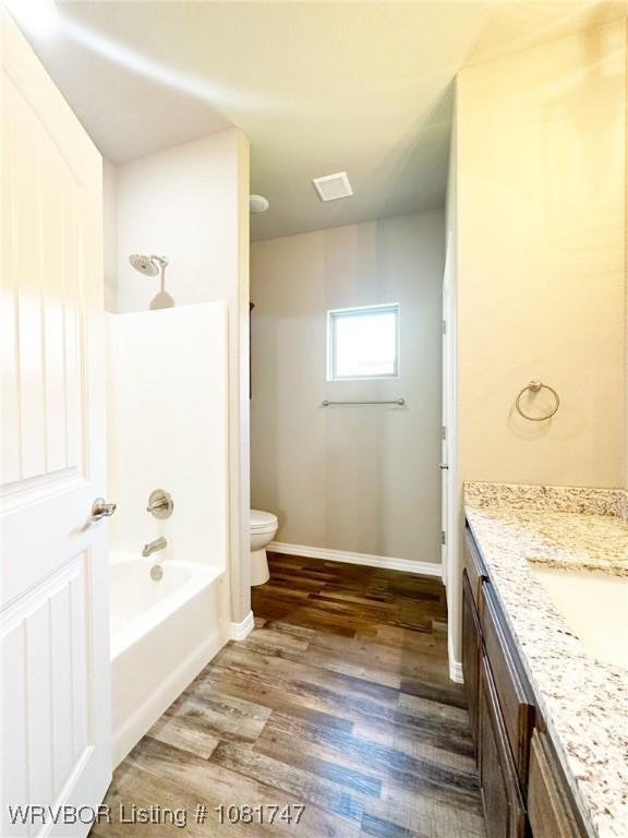 2060 W Breckenridge St, Sallisaw, OK 74955 - full bath featuring vanity, wood finished floors, and washtub / shower combination