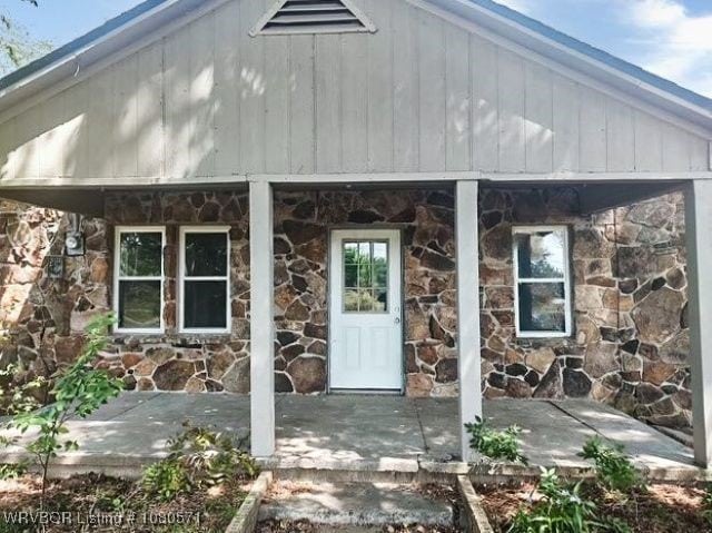 property entrance with stone siding