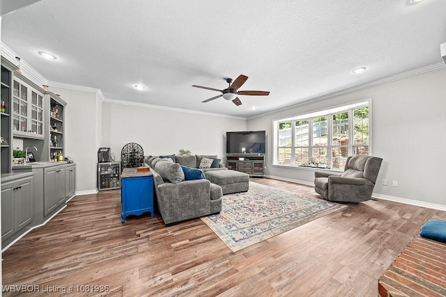 9301 Canopy Oaks Dr, Fort Smith, AR 72903 - living room with wood finished floors, ceiling fan, ornamental molding, recessed lighting, and a textured ceiling