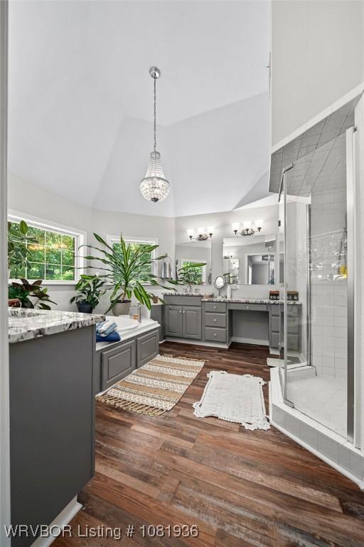 9301 Canopy Oaks Dr, Fort Smith, AR 72903 - bathroom featuring vanity, a shower stall, wood finished floors, and high vaulted ceiling