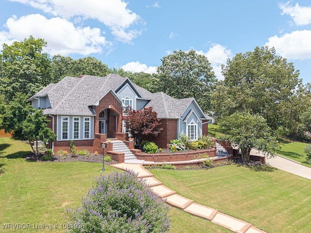 9301 Canopy Oaks Dr, Fort Smith, AR 72903 - traditional-style home featuring brick siding, a front yard, and a shingled roof