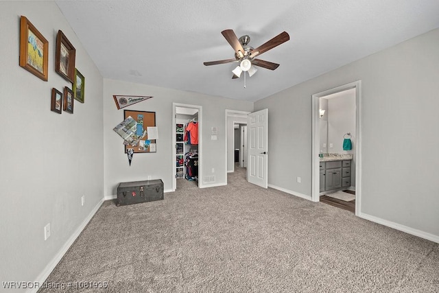 9301 Canopy Oaks Dr, Fort Smith, AR 72903 - unfurnished bedroom with a spacious closet, carpet floors, a closet, ensuite bath, and a ceiling fan