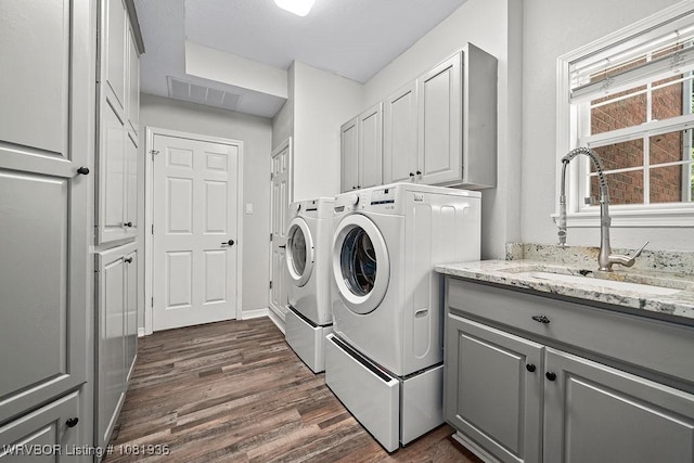 9301 Canopy Oaks Dr, Fort Smith, AR 72903 - washroom featuring washer and clothes dryer, dark wood-type flooring, and cabinet space