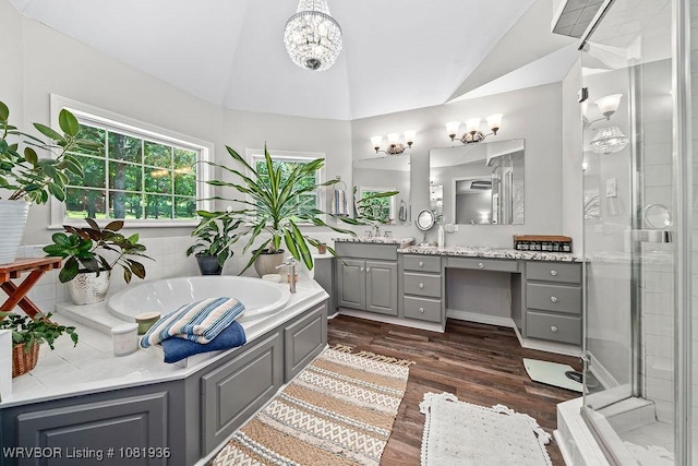 9301 Canopy Oaks Dr, Fort Smith, AR 72903 - full bathroom with lofted ceiling, vanity, a stall shower, wood finished floors, and a garden tub