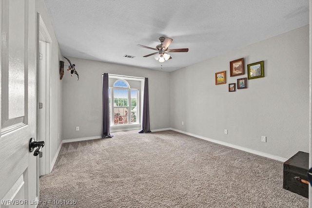 9301 Canopy Oaks Dr, Fort Smith, AR 72903 - spare room featuring ceiling fan, carpet, and a textured ceiling