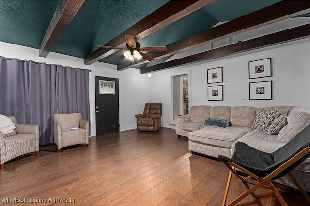 living room featuring vaulted ceiling with beams, hardwood / wood-style flooring, and ceiling fan