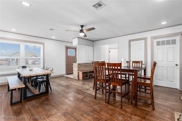 dining area with ceiling fan and dark hardwood / wood-style flooring