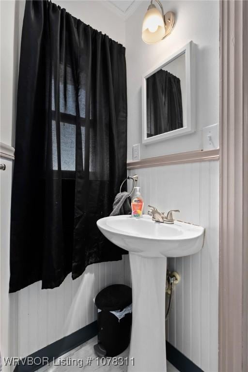 bathroom with sink and crown molding