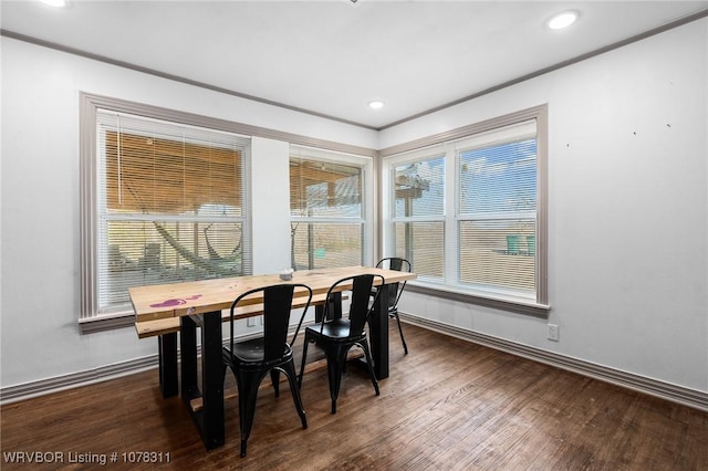 dining room featuring dark hardwood / wood-style floors and crown molding