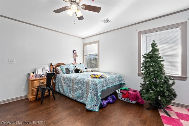 bedroom with dark hardwood / wood-style floors, ceiling fan, and ornamental molding