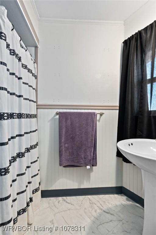 bathroom with crown molding and sink