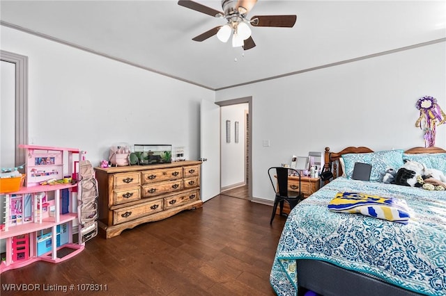 bedroom featuring ceiling fan, dark hardwood / wood-style flooring, and ornamental molding