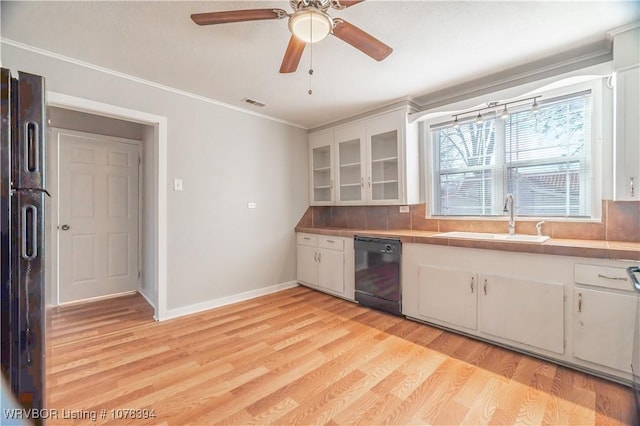 kitchen with refrigerator, dishwasher, tasteful backsplash, white cabinets, and sink