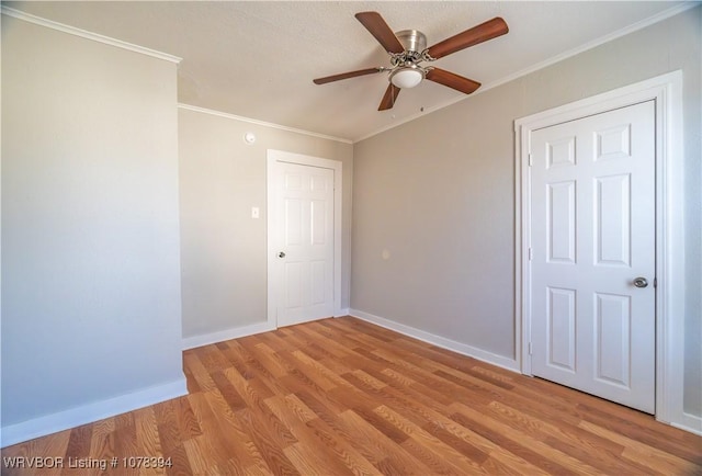 unfurnished room with ornamental molding, ceiling fan, and light hardwood / wood-style flooring