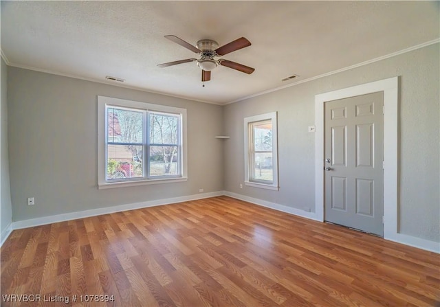 unfurnished room featuring ceiling fan, a textured ceiling, ornamental molding, and light hardwood / wood-style floors