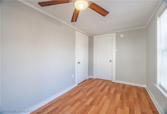 spare room with ornamental molding, ceiling fan, and light wood-type flooring