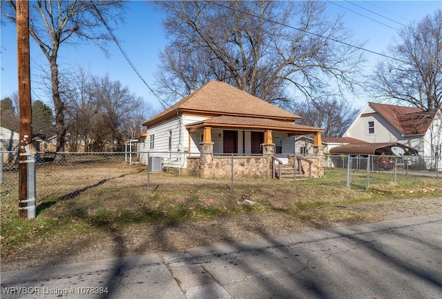 bungalow-style home featuring a porch and central AC unit