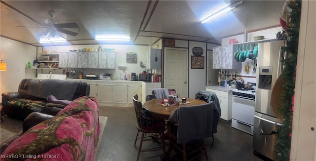 dining room with a ceiling fan, concrete flooring, and a textured ceiling