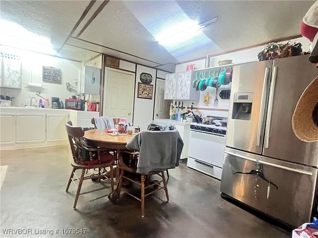 dining room with a textured ceiling and concrete flooring