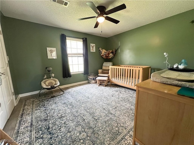 801 Northview Dr, Van Buren, AR 72956 - carpeted bedroom with a textured ceiling, ceiling fan, and a crib