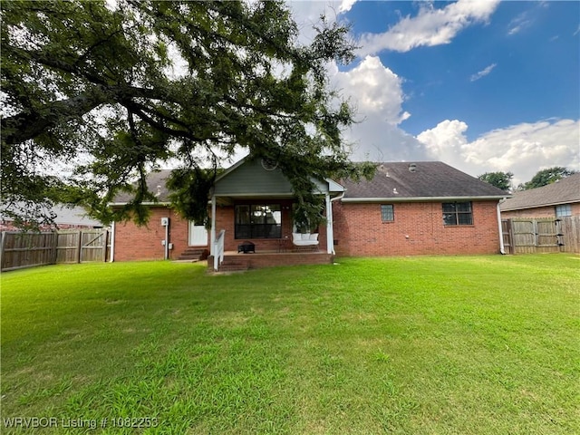 801 Northview Dr, Van Buren, AR 72956 - back of property featuring a fenced backyard, brick siding, and entry steps
