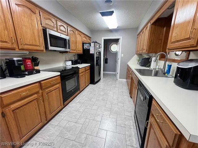 801 Northview Dr, Van Buren, AR 72956 - kitchen with black appliances, brown cabinetry, light countertops, and a textured ceiling