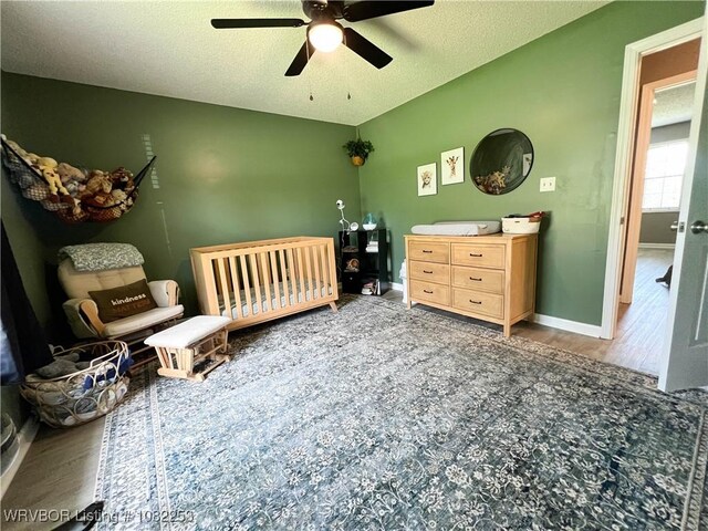 801 Northview Dr, Van Buren, AR 72956 - bedroom with wood finished floors, a crib, and ceiling fan