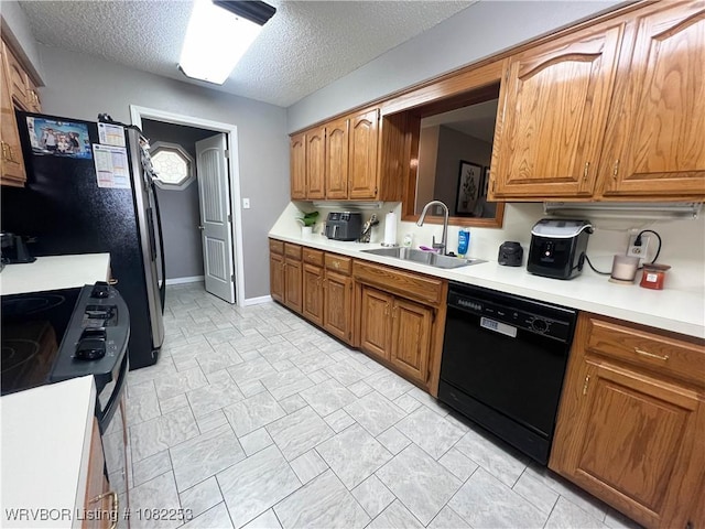 801 Northview Dr, Van Buren, AR 72956 - kitchen featuring black appliances, light countertops, brown cabinets, and a textured ceiling