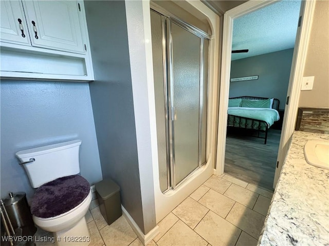 801 Northview Dr, Van Buren, AR 72956 - ensuite bathroom featuring a shower stall, vanity, a textured ceiling, and tile patterned floors