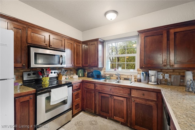 kitchen featuring stainless steel appliances, tasteful backsplash, and sink