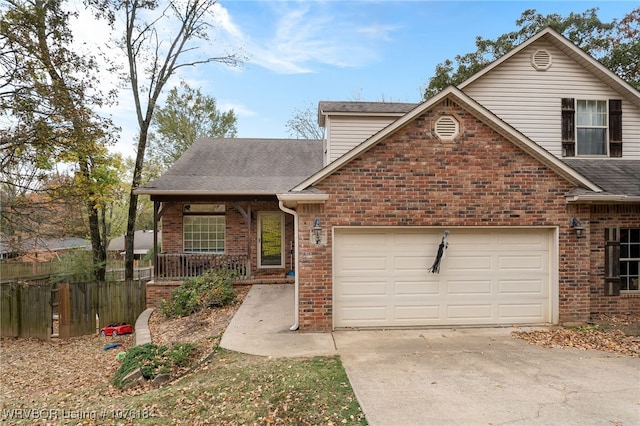 front of property featuring a porch and a garage