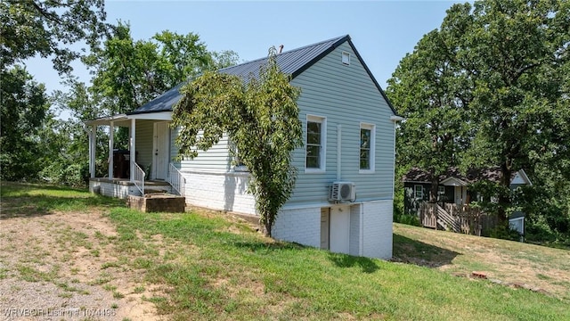 view of home's exterior with ac unit and a lawn