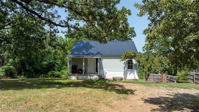 rear view of property featuring a yard