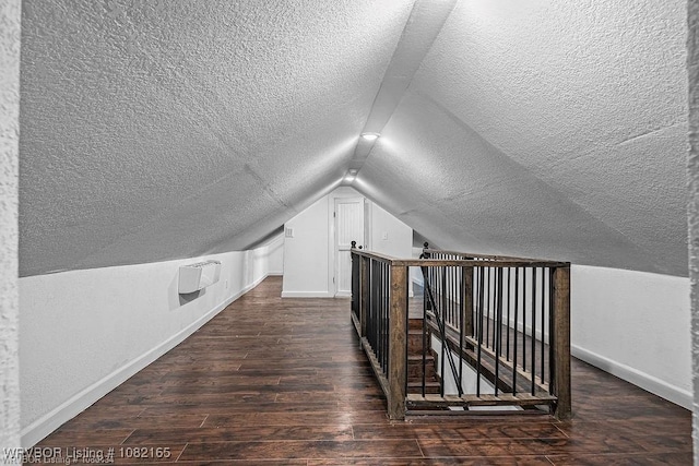 802 N 11th St, Van Buren, AR 72956 - additional living space featuring a textured ceiling, lofted ceiling, and dark wood-type flooring