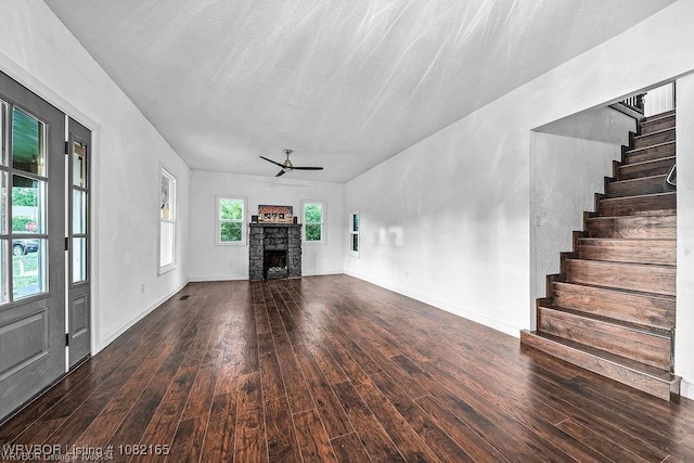 802 N 11th St, Van Buren, AR 72956 - unfurnished living room with wood-type flooring, a ceiling fan, stairway, and a fireplace