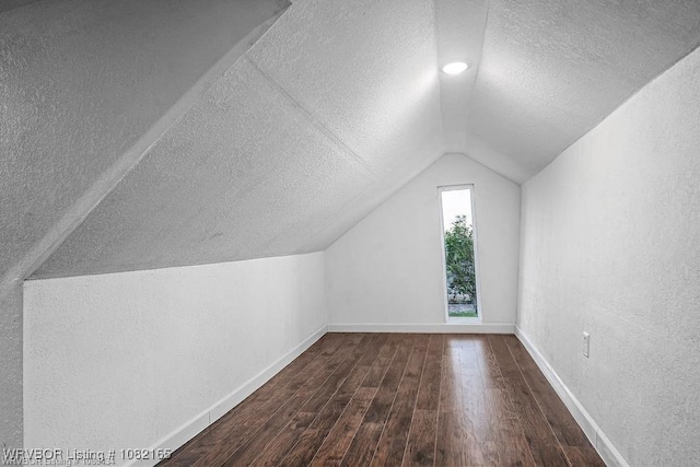 802 N 11th St, Van Buren, AR 72956 - bonus room featuring a textured ceiling, vaulted ceiling, wood finished floors, and a textured wall