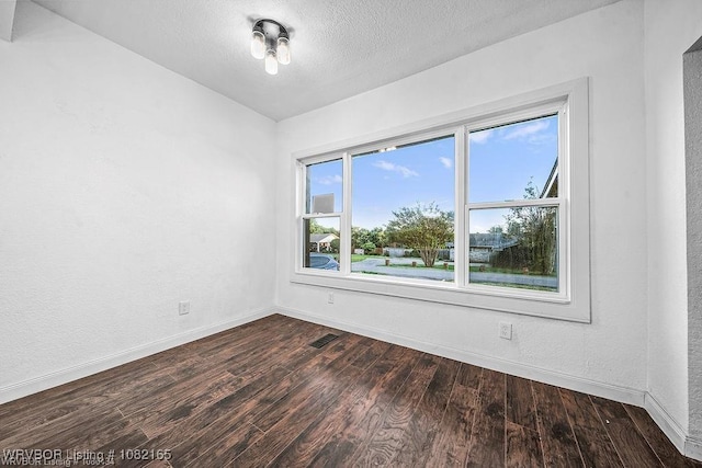 802 N 11th St, Van Buren, AR 72956 - spare room with dark wood-style floors and a textured ceiling