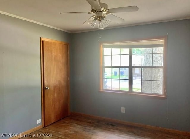 empty room featuring ceiling fan, ornamental molding, and hardwood / wood-style flooring