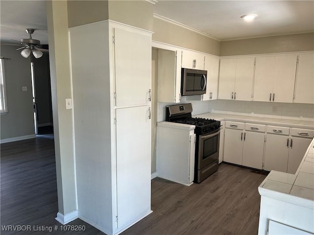 kitchen with white cabinetry, stainless steel appliances, tasteful backsplash, dark hardwood / wood-style floors, and tile countertops