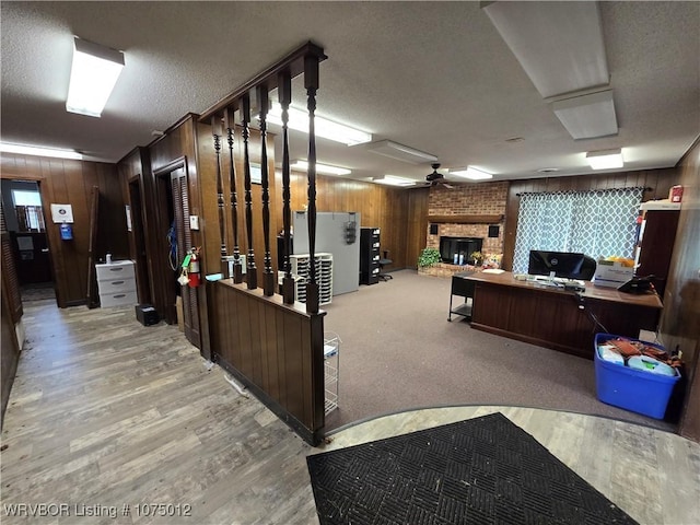 reception area with ceiling fan and a brick fireplace