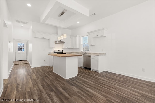 kitchen featuring dark wood finished floors, butcher block counters, visible vents, appliances with stainless steel finishes, and under cabinet range hood