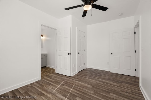 unfurnished bedroom with ceiling fan, dark wood-type flooring, and baseboards