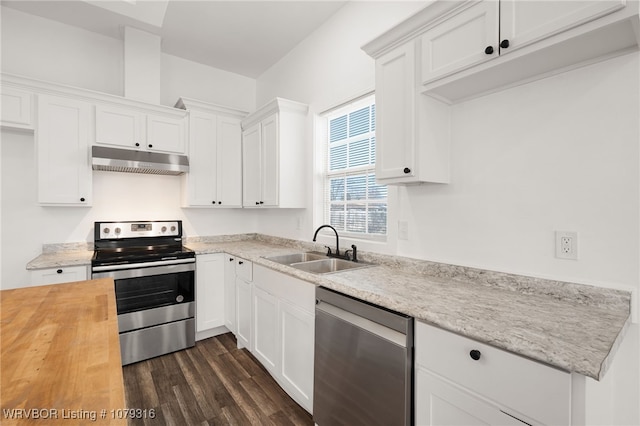 kitchen featuring white cabinets, butcher block countertops, appliances with stainless steel finishes, under cabinet range hood, and a sink