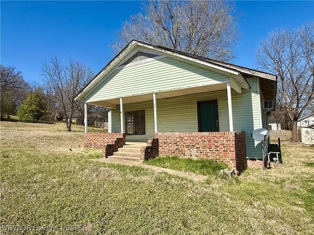 bungalow-style home featuring a porch and a front lawn