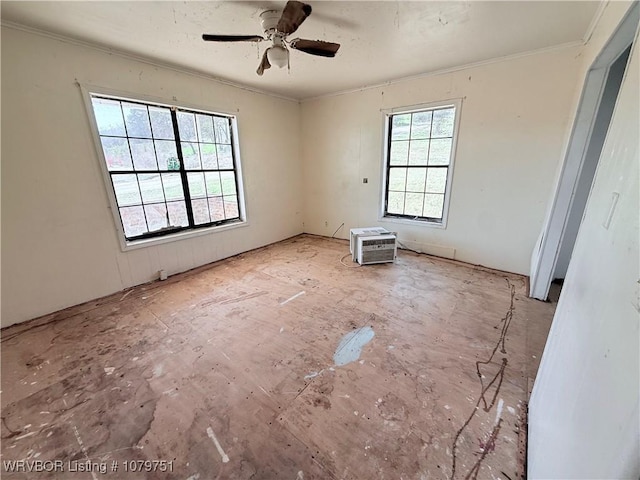 spare room featuring a ceiling fan and crown molding