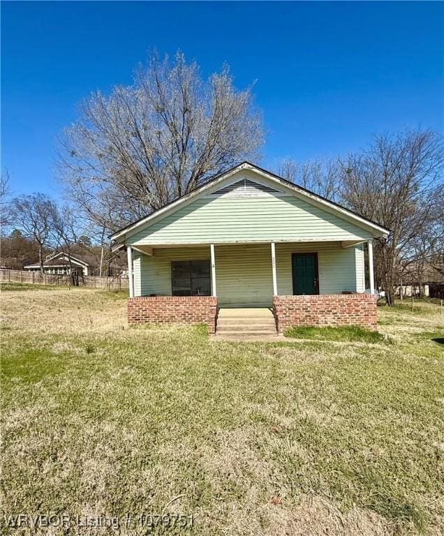 view of front of property with a porch and a front yard