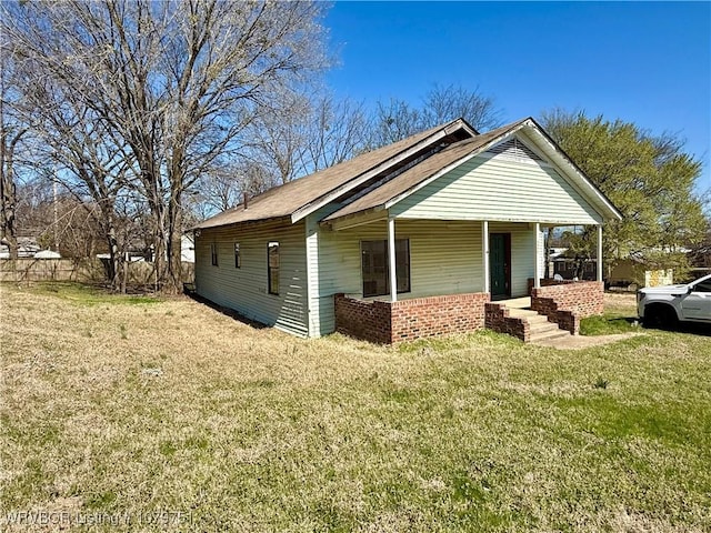 view of property exterior with a lawn and covered porch