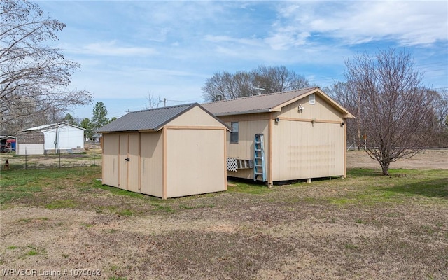 view of outbuilding featuring a lawn