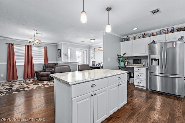 kitchen with a center island, decorative light fixtures, white cabinetry, and stainless steel fridge with ice dispenser