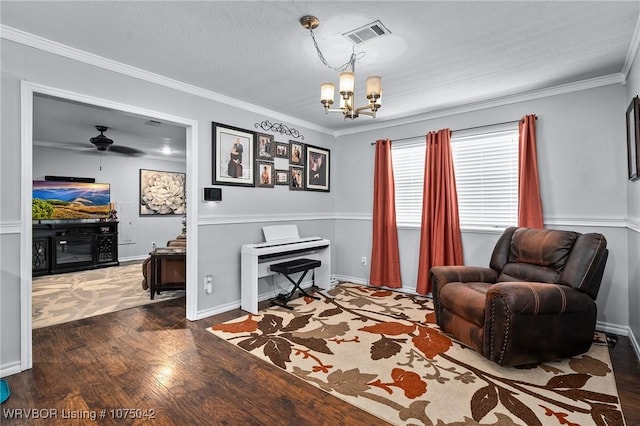 living area with dark hardwood / wood-style flooring, ceiling fan with notable chandelier, and ornamental molding